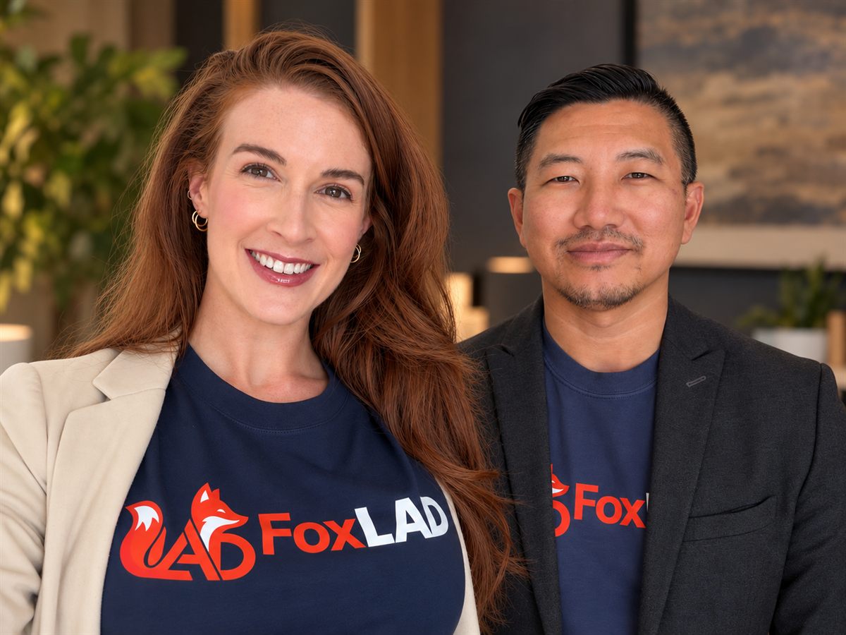 FoxLAD co-founders Oakley Smith and Mong Nguyen smiling together in navy FoxLAD shirts.
